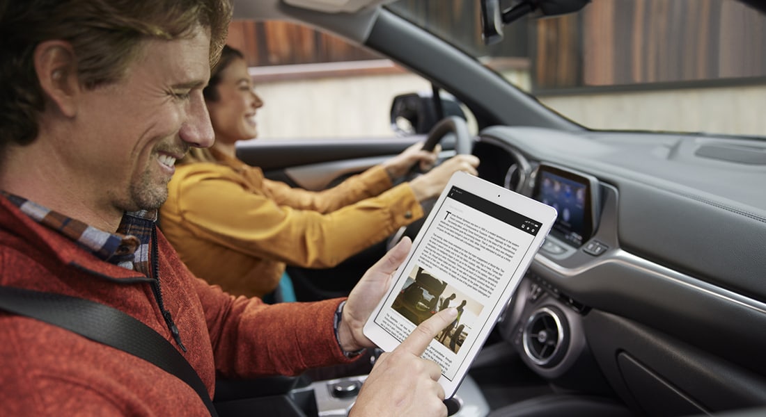 passenger using a tablet in a Chevy