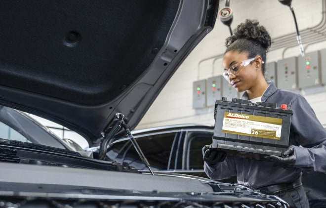A service technician installing a battery