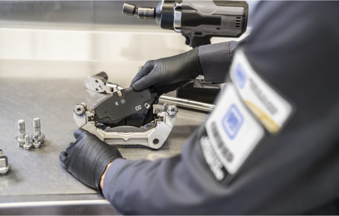 GM service technician checking a brake pad
